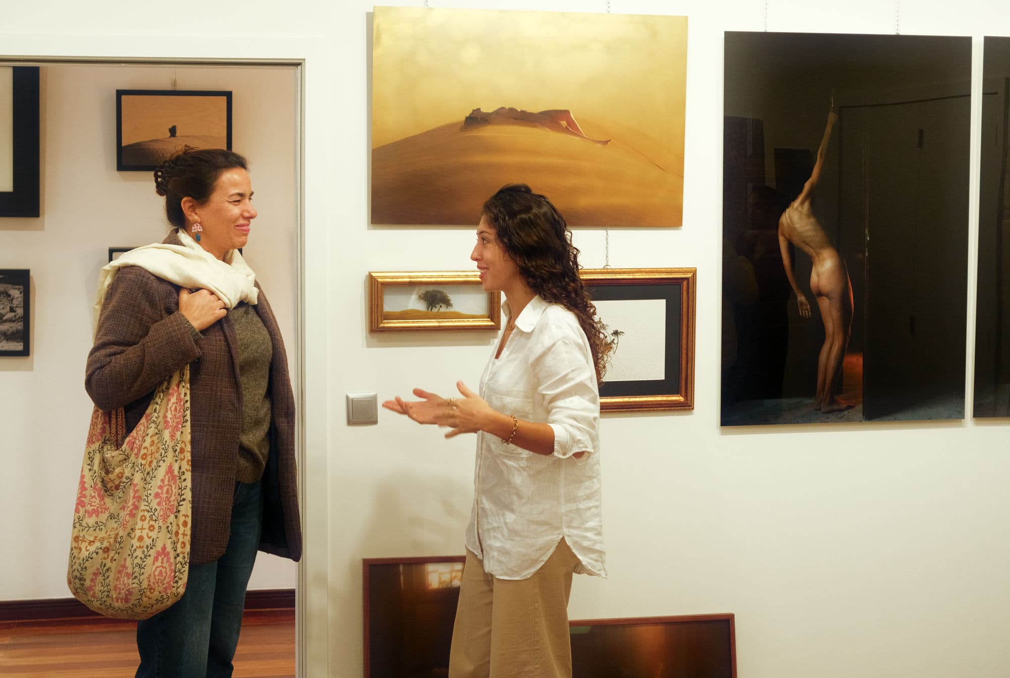 Soraia in the gallery, in conversation with a visitor